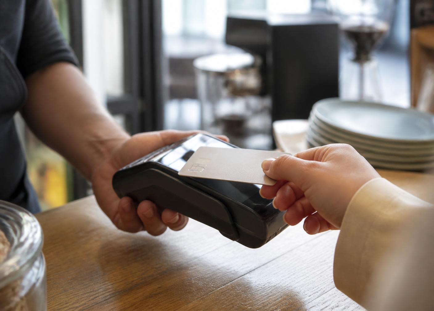 Customer paying with a bank card at a shop counter